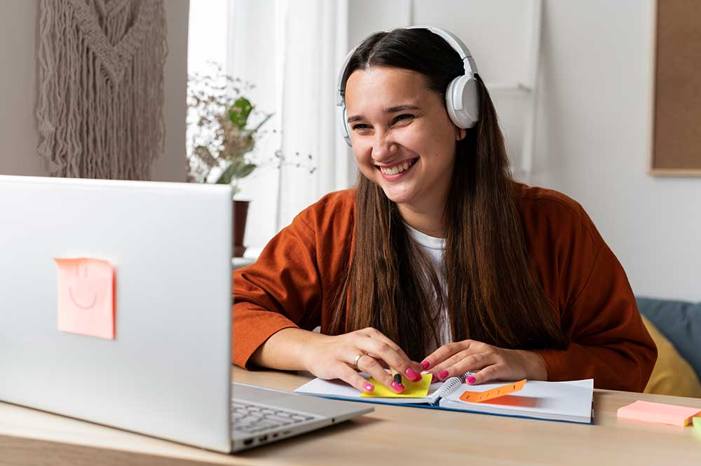 A learner practising English online with headphones